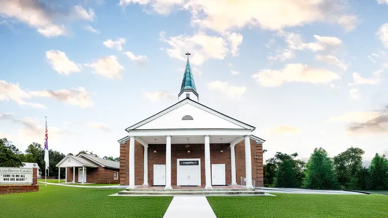 The red brick sanctuary of Sauldam Baptist Church, with its white portico and steeple, under a Lowcountry sky.